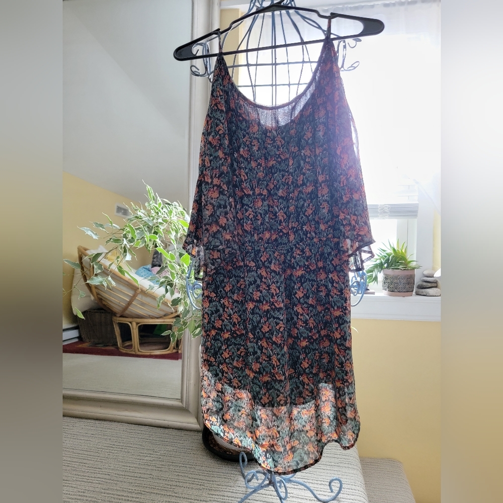 Cold shoulder, sheer, blousy dress with a cinched waste.